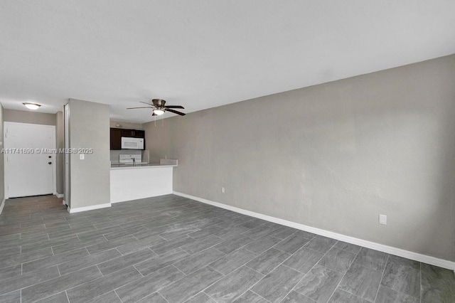 unfurnished living room with ceiling fan