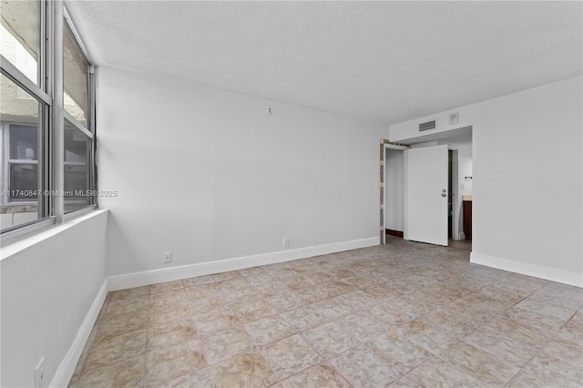 empty room featuring a textured ceiling