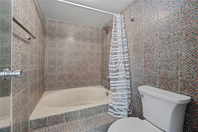 bathroom with toilet, tile walls, and shower / bath combo