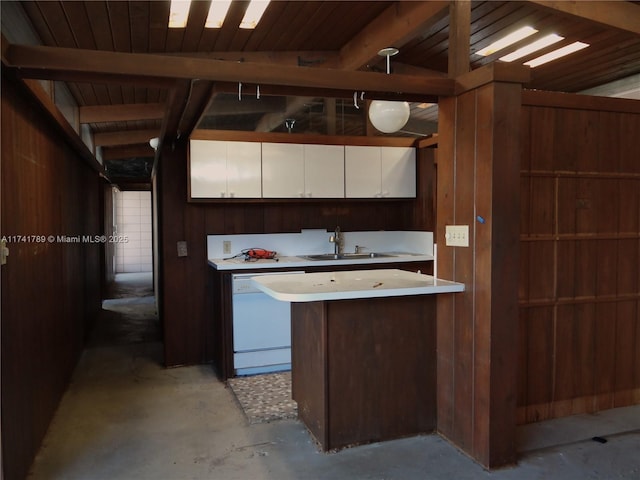 kitchen with white cabinets, sink, beamed ceiling, and dishwasher