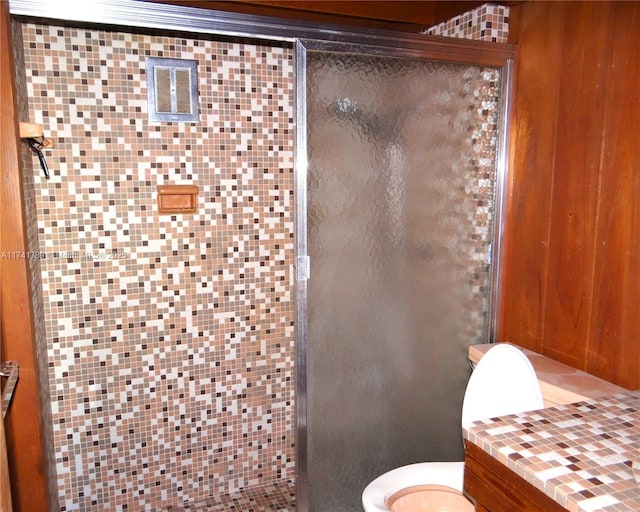 bathroom with toilet and walk in shower