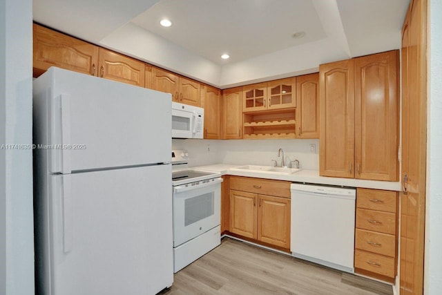 kitchen with sink, white appliances, and light wood-type flooring