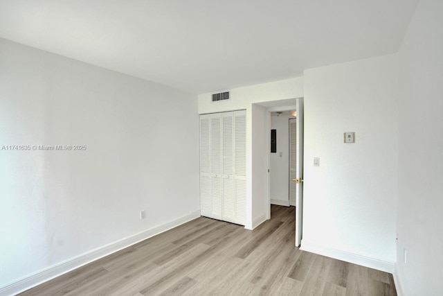 empty room with light hardwood / wood-style floors