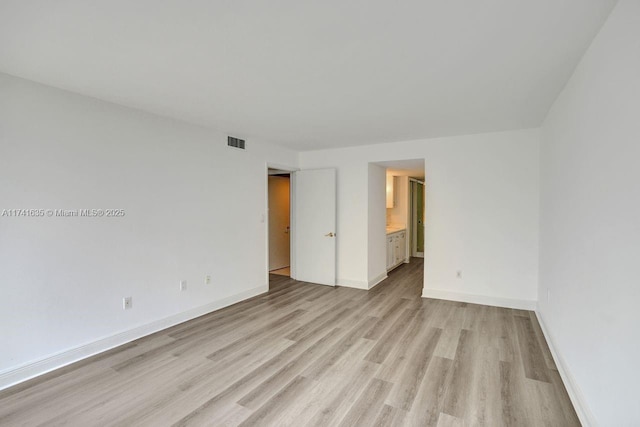 spare room with light wood-type flooring