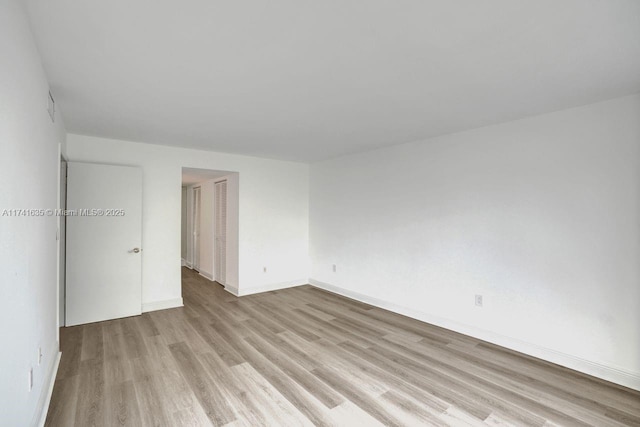 spare room with light hardwood / wood-style floors