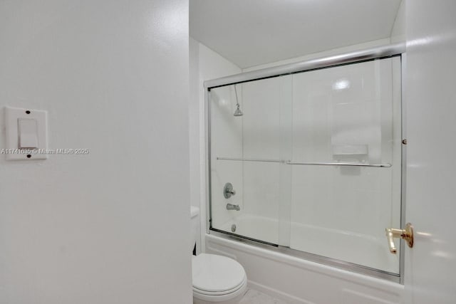 bathroom featuring enclosed tub / shower combo and toilet