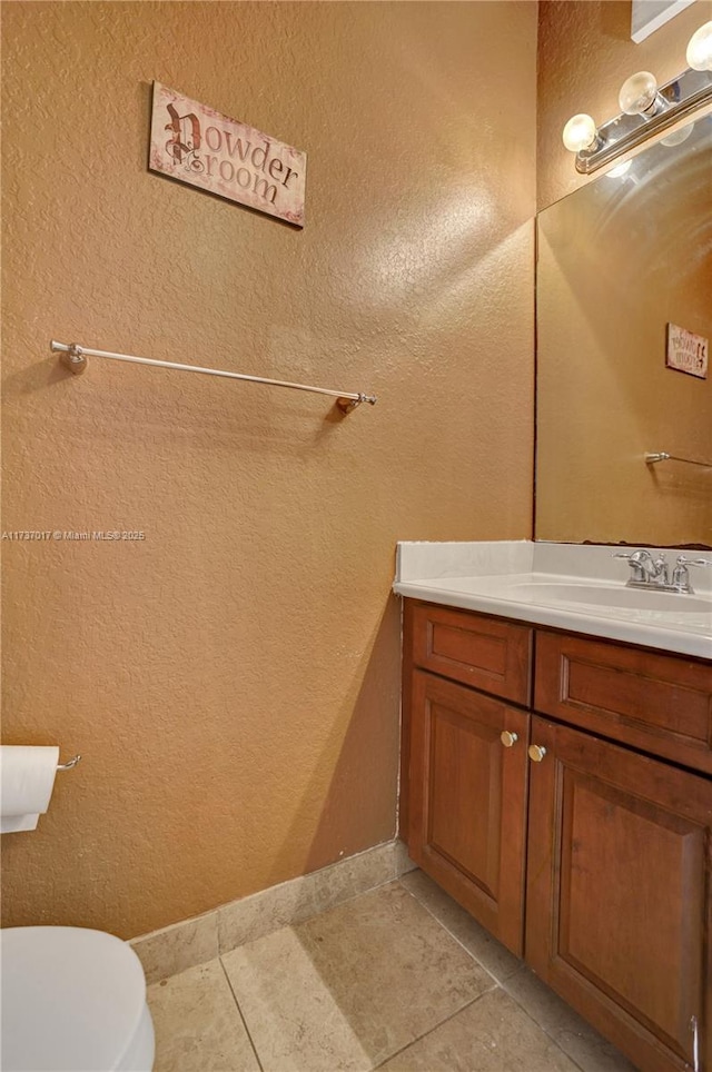 bathroom with vanity, tile patterned floors, and toilet