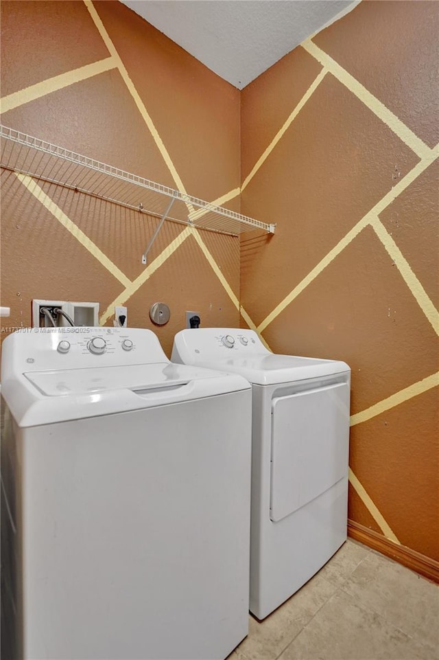 laundry area featuring independent washer and dryer and tile patterned floors