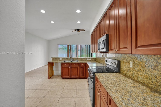 kitchen featuring sink, appliances with stainless steel finishes, light stone counters, decorative backsplash, and vaulted ceiling