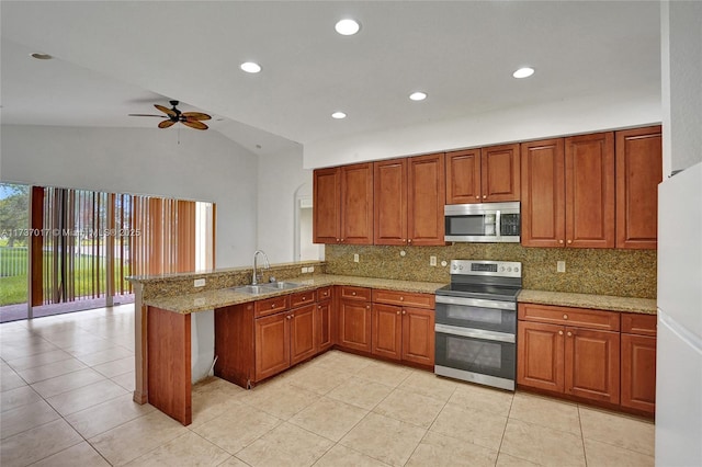 kitchen with appliances with stainless steel finishes, tasteful backsplash, sink, light stone counters, and kitchen peninsula