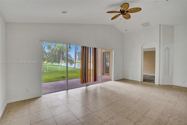 unfurnished room featuring lofted ceiling, light tile patterned floors, and ceiling fan