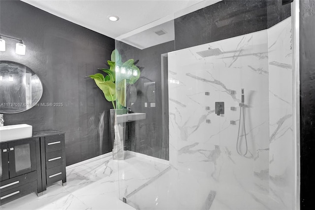 bathroom featuring vanity and tiled shower