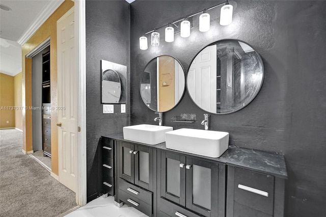 bathroom with crown molding and vanity