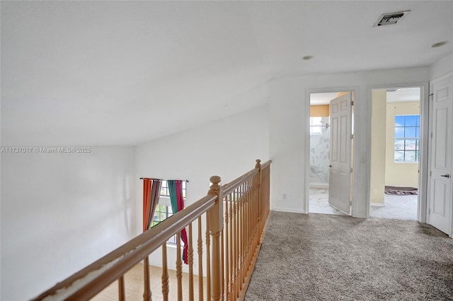 corridor featuring light colored carpet