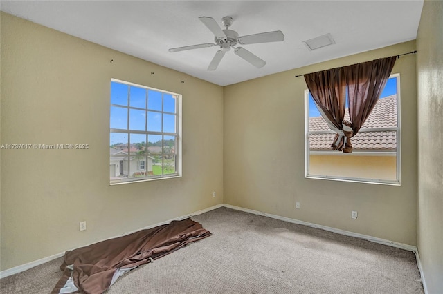 empty room with ceiling fan and carpet flooring