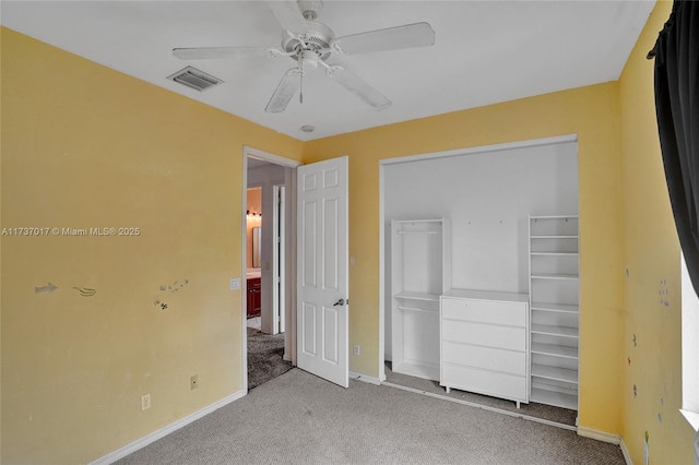 unfurnished bedroom featuring light carpet, a closet, and ceiling fan