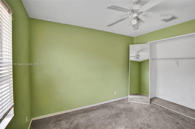 unfurnished bedroom with carpet floors, ceiling fan, and a closet