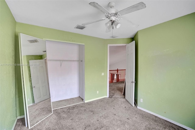 unfurnished bedroom with ceiling fan, light colored carpet, and a closet