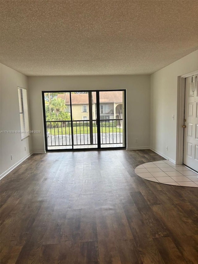 spare room with wood-type flooring and a textured ceiling