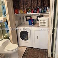 laundry room with separate washer and dryer and tile patterned floors