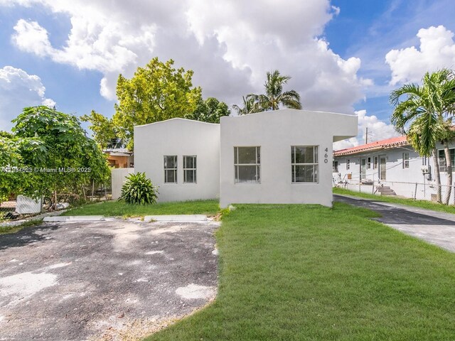 back of house with a lawn