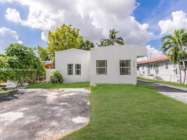 back of house with a lawn