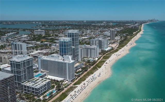 aerial view with a water view and a beach view