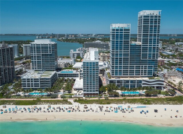 drone / aerial view featuring a water view and a beach view