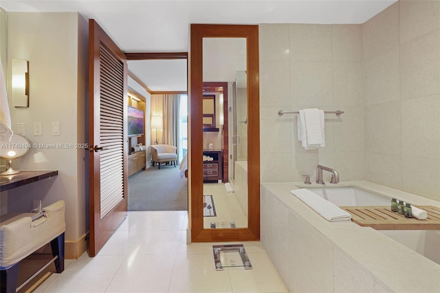 bathroom featuring a relaxing tiled tub, tile patterned floors, and tile walls