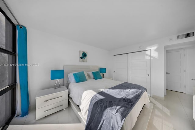 tiled bedroom featuring a closet