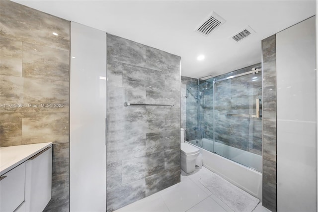 full bathroom with tile walls, vanity, tile patterned flooring, and combined bath / shower with glass door