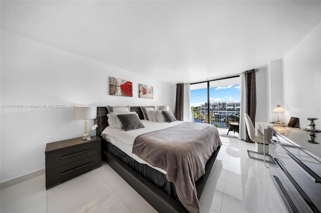 bedroom with access to exterior, light tile patterned floors, and expansive windows