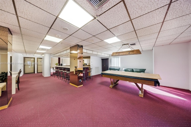 rec room featuring a paneled ceiling and carpet flooring