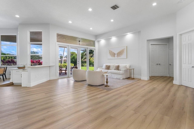 living room featuring french doors and light wood-type flooring