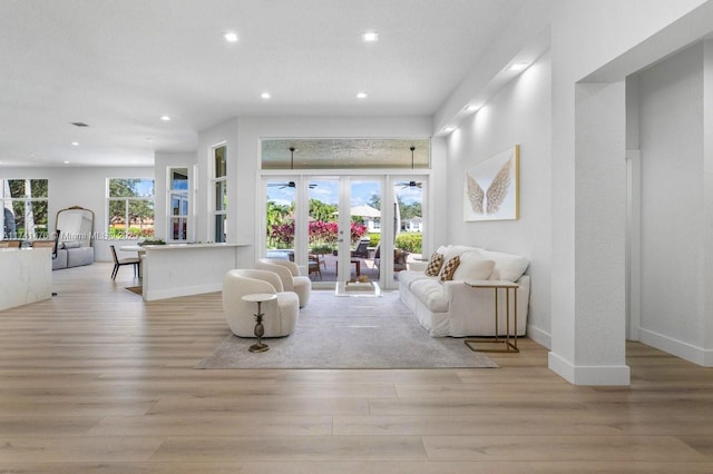 living room with french doors and light wood-type flooring