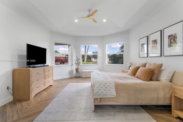 bedroom with multiple windows, light parquet flooring, and ceiling fan