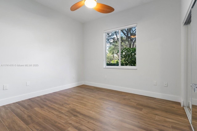 spare room featuring ceiling fan and dark hardwood / wood-style flooring