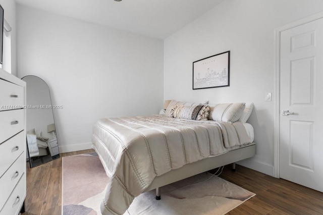 bedroom with dark hardwood / wood-style flooring