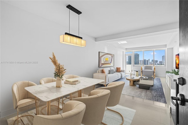 tiled dining space featuring beamed ceiling