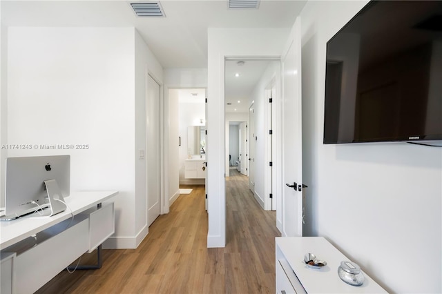 corridor with light wood-type flooring