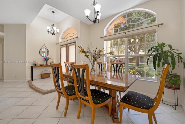 dining room featuring a chandelier, baseboards, and light tile patterned floors