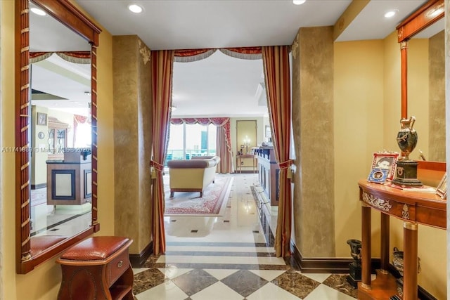 corridor featuring tile patterned floors, baseboards, and recessed lighting