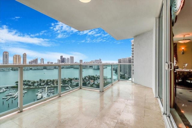 balcony with a water view and a view of city