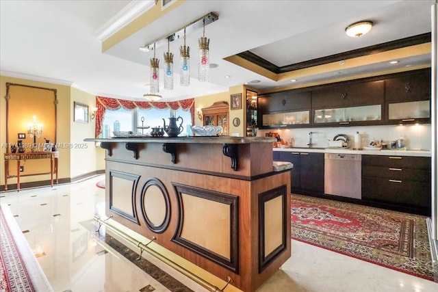 interior space featuring ornamental molding, glass insert cabinets, dishwashing machine, and a kitchen bar