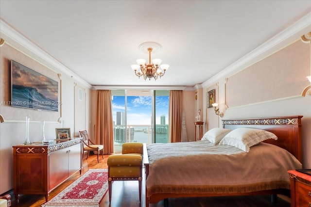 bedroom with wood finished floors, an inviting chandelier, access to outside, a wall of windows, and crown molding