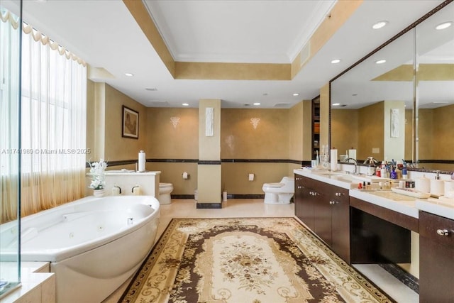 full bath with a raised ceiling, toilet, ornamental molding, vanity, and a whirlpool tub