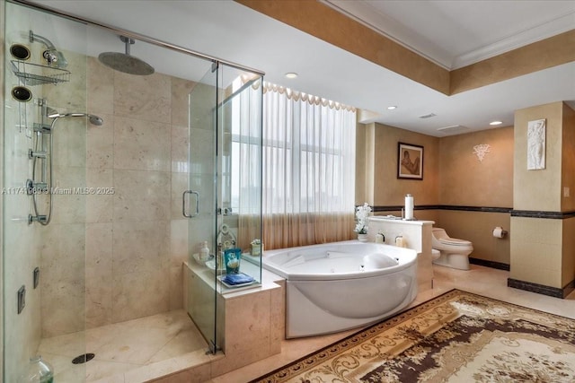 bathroom featuring tile patterned flooring, toilet, a jetted tub, a stall shower, and crown molding