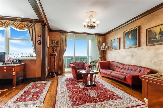 living room featuring ornamental molding, expansive windows, a chandelier, and wood finished floors