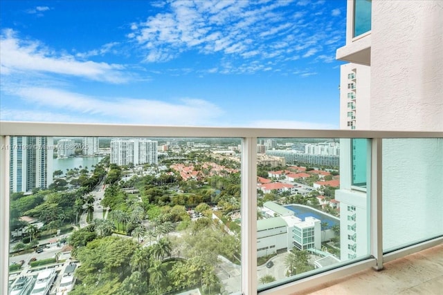 balcony featuring a water view and a city view