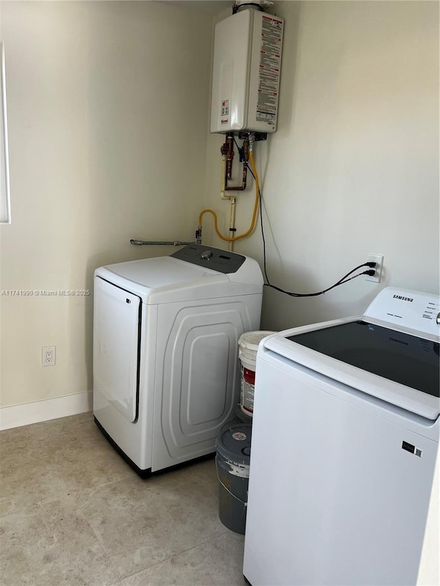 laundry room featuring water heater and independent washer and dryer